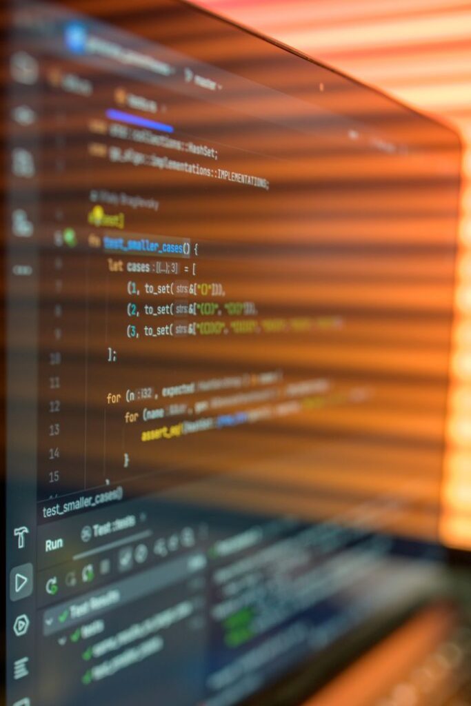 The Art of Drawing Readers In: Your attractive post title goes here Close-up image of a computer screen displaying colorful programming code in a warm setting.